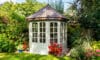 A bespoke white summerhouse with elegant glass windows